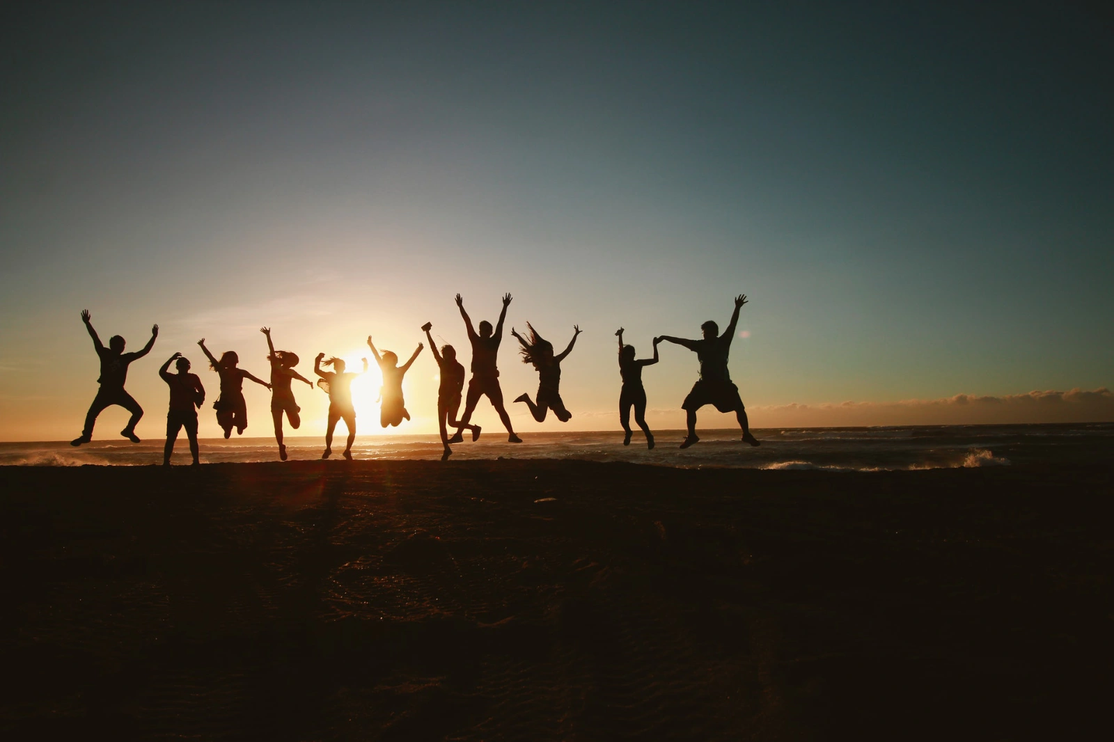 Group of adults jumps with joy